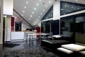 a living room with a couch and a table in a kitchen at Ioannina Luxury Suites & Apartments in Ioannina