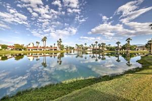 a large lake with palm trees and houses at Mtn-View Rancho Mirage Condo with Lakefront Patio in Rancho Mirage