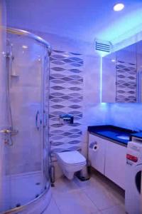 a bathroom with a shower and a toilet and a sink at Nupelda Residence Hotel in Istanbul +54 photos