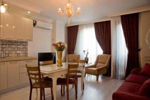 a kitchen and living room with a table and chairs at Nupelda Residence Hotel in Istanbul