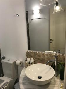 La salle de bains est pourvue d'un lavabo et de toilettes. dans l'établissement Paxos Santa Marina Villas, à Gaios