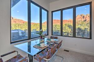 
a dining room table with chairs and a window at 2-Acre Sedona Casita with Deck and Red Rock Views! in Sedona
