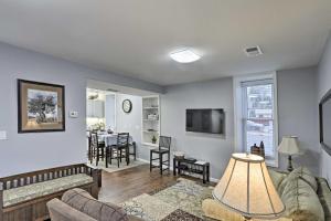 a living room with a couch and a table at Historic Laramie Condo - 3 Blocks to Downtown and UW in Laramie