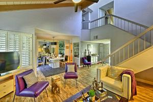 a living room with purple chairs and a staircase at Palm Springs Townhome with Pool and Golf Access! in Palm Springs