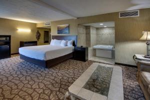 a large hotel room with a bed and a couch at EverSpring Inn in Bismarck +44 photos