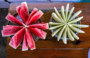 two slices of fruit on a wooden table at Cururupe Praia Hotel in Ilhéus