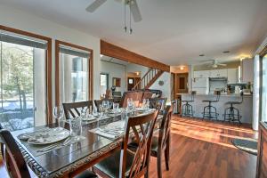 a dining room and kitchen with a table and chairs at Poconos Vacation Rental with Pool Access and Hot Tub! in Bushkill