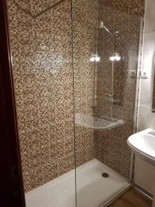 a shower with a glass door in a bathroom at Residencial Solar da Estação in Barcelos