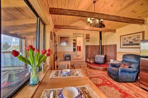 a living room with a vase of flowers on a table at Idyllic Dolores Cabin with Fire Pit and Lake Views! in Dolores
