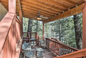 a porch of a cabin with chairs and tables at Cloudcroft Cabin with Deck Near Skiing and Fishing! in Cloudcroft