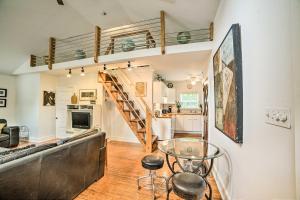 a living room with a spiral staircase and a glass table at Modern St Elmo Cottage by Lookout Mtn and Near Dwtn in Chattanooga