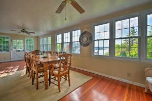 a dining room with a table and chairs and windows at Waterfront Harveys Lake House with Private Dock! in Harveys Lake