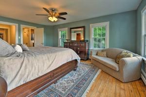 a bedroom with a bed and a couch and a fan at Waterfront Harveys Lake House with Private Dock! in Harveys Lake