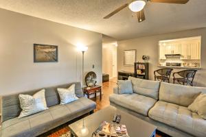 a living room with two couches and a kitchen at Mount Pleasant Condo - Near Charleston and Beaches! in Charleston