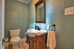 a bathroom with a sink and a toilet and a mirror at Waterfront Harveys Lake House with Private Dock! in Harveys Lake +24 photos