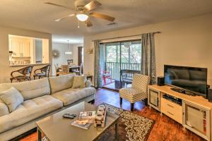 a living room with a couch and a flat screen tv at Mount Pleasant Condo - Near Charleston and Beaches! in Charleston