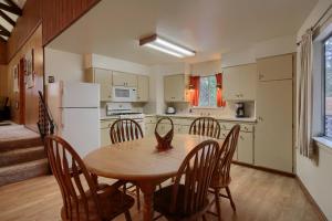 a kitchen with a table and chairs and a refrigerator at 25A Villarreal Retreat in Wawona