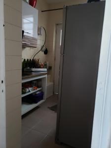 a black refrigerator in a kitchen with its door open at Cantinho em Santa Teresa com bichinho de estimaçao in Rio de Janeiro