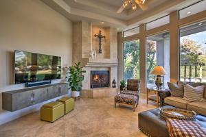 a living room with a fireplace and a tv at Lavish Paradise Valley Home with Sports Court and Pool in Scottsdale