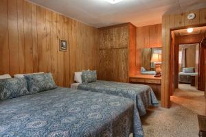 a hotel room with two beds and a mirror at 25A Villarreal Retreat in Wawona