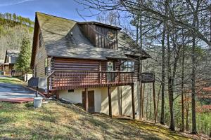 a large house with a deck on a hill at Sevierville Cabin with Hot Tub, Views and Pool Access! in Sevierville