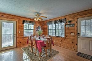 a dining room with a table and a ceiling fan at Sevierville Cabin with Hot Tub, Views and Pool Access! in Sevierville