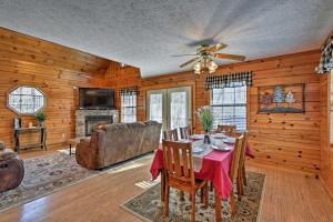 a dining room with a table and a couch at Sevierville Cabin with Hot Tub, Views and Pool Access! in Sevierville