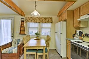 a kitchen with a table and chairs in a room at Charming Surf City Cottage - Steps to Beach and Bay! in Surf City