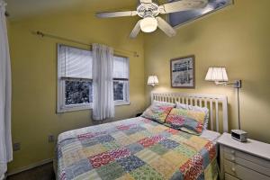 a bedroom with a bed and a ceiling fan at Charming Surf City Cottage - Steps to Beach and Bay! in Surf City