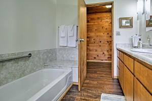a bathroom with a tub and a sink at Cozy Home with Patio Near Yosemite National Park! in Mariposa +16 photos