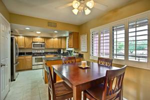 a large kitchen with a wooden table and chairs at Anasazi Village Condo, 8Mi to Phoenix Mtn Preserve in Phoenix