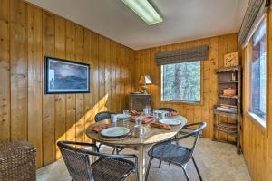 een houten eetkamer met een tafel en stoelen bij 5-Acre Allenspark Cabin with Rocky Mntn Views and Pond in Allenspark