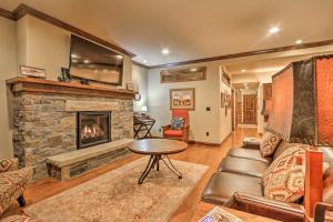 a living room with a couch and a fireplace at Red Lodge Townhome with Private Hot Tub and Mtn Views! in Red Lodge