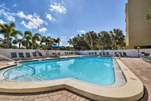 a swimming pool at a resort with palm trees at Indian Shores Condo with 2 Balconies and Pool Access! in Clearwater Beach
