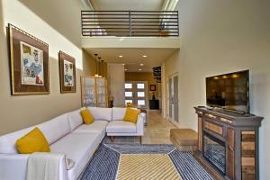 a living room with a white couch and a fireplace at Cozy Casita with Mtn View and Pool and Hot Tub Access in Carefree