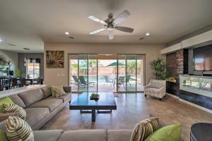 a living room with a couch and a ceiling fan at Hot Tub and Putting Green Home in Surprise in Surprise