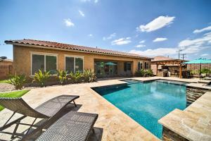 a swimming pool with a chair and a house at Hot Tub and Putting Green Home in Surprise in Surprise