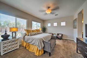 a bedroom with a bed and a ceiling fan at Hot Tub and Putting Green Home in Surprise in Surprise +19 photos