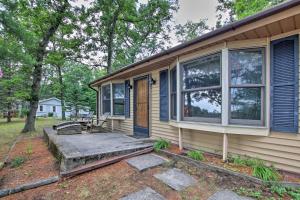 a house with a front porch and a door at Baldwin Cabin with Private Beach on Little Lake! in Baldwin