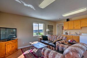 a living room with a couch and a tv at Charming Barn Apt in Boulder! Gateway to Parks! in Boulder Town