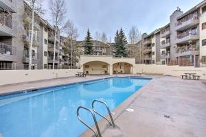 a swimming pool with tables and benches in a building at Colorado Escape w/ Pool Access & Mountain Views! in Avon