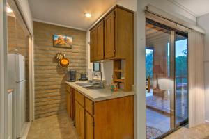a kitchen with a sink and a refrigerator at Romantic Sedona Suite with Patio Less Than 1 Mi to Trails in Sedona