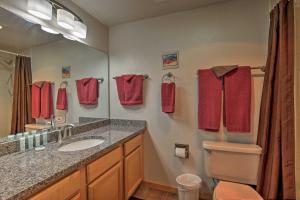 a bathroom with a sink and a toilet and a mirror at 360 Mtn Views and Shared Hot Tub Cozy Frisco Condo! in Frisco +20 photos