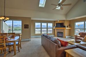 a living room with a couch and a table at 360 Mtn Views and Shared Hot Tub Cozy Frisco Condo! in Frisco