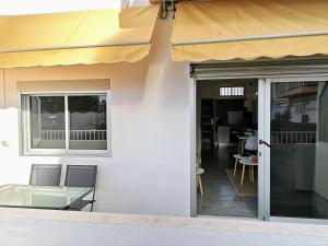 a patio with a table and chairs outside of a building at VV Sweet Home Playa del Inglés "by henrypole home" in San Bartolomé