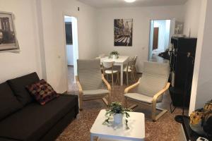 - un salon avec un canapé, des chaises et une table dans l'établissement Céntrico apartamento para 6 en Benidorm, à Benidorm