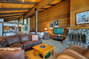 a living room with leather furniture and a fireplace at 11 Mi to Palisades Tahoe Lakefront Home with View! in Tahoe City