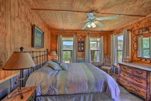 a bedroom with a bed and a ceiling fan at Cozy Medina Cottages with Patio and Mountain Views! in Medina