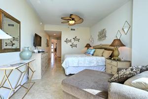 a bedroom with a bed and a ceiling fan at Beachfront Condo with Pool Access in Biloxi! in Biloxi