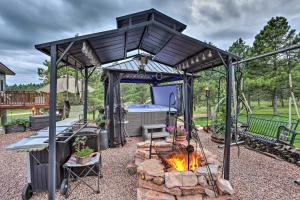 a gazebo with a fire pit in a backyard at The Apartment Retreat Near Mount Rushmore in Hermosa